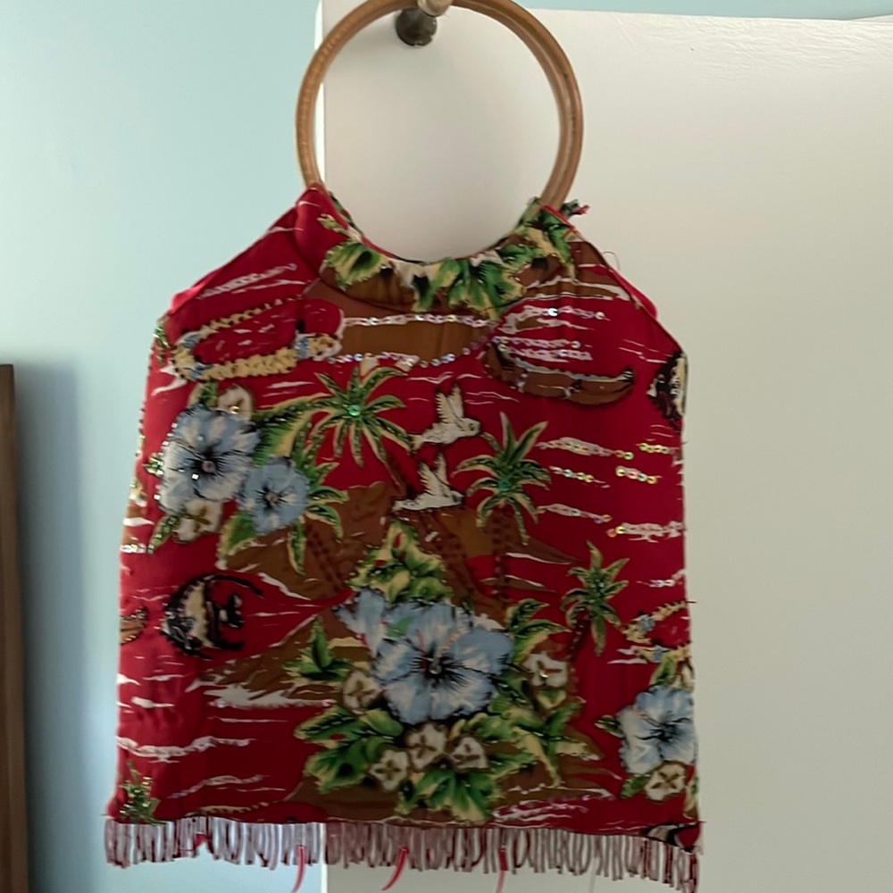 Fun summer bag with beaded front and back, plus beaded fringe.Lined in red satin